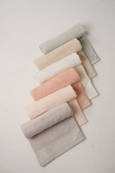 A neat stack of yoga blocks and a rolled towel in a serene studio setting.